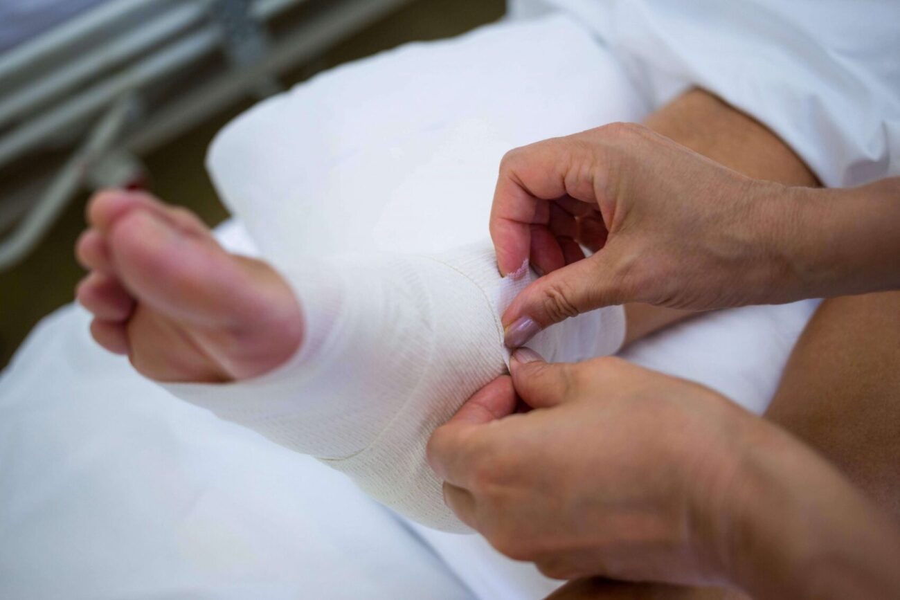 doctor bandaging patients leg